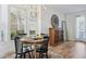 Elegant dining room featuring hardwood floors, a stylish chandelier, and a round table with seating at 1555 Napoli W Dr, Sarasota, FL 34232