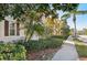 Street view of attractive townhomes boasting well-maintained landscaping and charming architectural details at 1555 Napoli W Dr, Sarasota, FL 34232