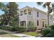 Stunning multi-story home featuring classic architecture, manicured landscaping, and a welcoming entrance at 1555 Napoli W Dr, Sarasota, FL 34232