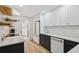 Modern kitchen boasts white cabinets, stainless appliances, and light countertops at 1555 Napoli W Dr, Sarasota, FL 34232