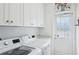 Laundry room featuring new washer and dryer and storage cabinets at 1555 Napoli W Dr, Sarasota, FL 34232