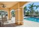 Resort-style pool featuring covered seating area for relaxation and shade at 1555 Napoli W Dr, Sarasota, FL 34232