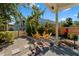 Backyard area featuring a gravel pathway, wooden deck and seating area with chairs surrounding a fire pit at 1609 1St W Ave, Bradenton, FL 34205