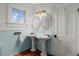 Elegant bathroom with pedestal sinks, ornate mirrors, and classic fixtures at 1609 1St W Ave, Bradenton, FL 34205