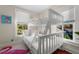 Bright bunk room with white bunk beds, colorful accents, and natural light at 1609 1St W Ave, Bradenton, FL 34205