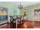 Elegant dining room with bright green accents, stylish chairs, and hardwood floors at 1609 1St W Ave, Bradenton, FL 34205