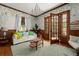 Bright living room with hardwood floors and natural light beaming through the set of French doors at 1609 1St W Ave, Bradenton, FL 34205