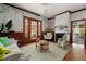 Cozy living room with a fireplace, wood trim, hardwood floors and lots of natural light at 1609 1St W Ave, Bradenton, FL 34205