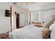 Well-lit primary bedroom with a tray on the bed, and light colored walls at 1609 1St W Ave, Bradenton, FL 34205