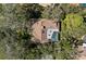 Aerial view of home showcasing the roof, landscaping and screened in pool at 1612 Pine Harrier Cir, Sarasota, FL 34231