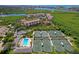 Aerial view of community including pool, tennis courts, lake, and other community amenities at 1612 Pine Harrier Cir, Sarasota, FL 34231