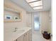 Bathroom featuring a modern sink and frosted glass door to the outside at 1612 Pine Harrier Cir, Sarasota, FL 34231