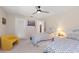 Bedroom featuring two beds, a ceiling fan, and a cozy yellow accent chair at 1612 Pine Harrier Cir, Sarasota, FL 34231