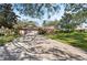 Wide brick driveway leading to a well-maintained home with a two-car garage and lush green lawn at 1612 Pine Harrier Cir, Sarasota, FL 34231