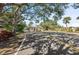 Community entry gate under mature trees provides privacy and a sense of exclusivity to the neighborhood at 1612 Pine Harrier Cir, Sarasota, FL 34231