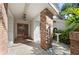 Welcoming front porch featuring a brick pillar, tiled pathway, and decorative plants at 1612 Pine Harrier Cir, Sarasota, FL 34231