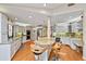 Spacious eat-in kitchen featuring white cabinets, granite countertops, a wine rack, and a breakfast bar at 1612 Pine Harrier Cir, Sarasota, FL 34231