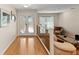 Bright living room with hardwood floors, a glass railing, and elegant French doors at 1612 Pine Harrier Cir, Sarasota, FL 34231