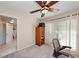 Bright office features neutral carpet, ceiling fan, and a large window at 1612 Pine Harrier Cir, Sarasota, FL 34231