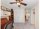 Inviting home office with custom built-ins, a ceiling fan, and neutral carpet at 1612 Pine Harrier Cir, Sarasota, FL 34231