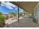 An inviting covered patio offers comfortable seating, an umbrella, and picturesque views of the pool at 1612 Pine Harrier Cir, Sarasota, FL 34231