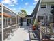 Wide shot of the backyard, featuring a screened-in patio, deck, and lush landscaping at 1627 Bayshore Dr, Englewood, FL 34223