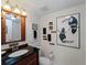 Bathroom with custom framed mirror, granite countertops, and eclectic decor at 1627 Bayshore Dr, Englewood, FL 34223