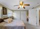 This is a standard bedroom with a ceiling fan, carpet, and a pair of closets at 1627 Bayshore Dr, Englewood, FL 34223