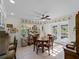 Sun-filled dining room with round wood table set, tile flooring, and a view to the deck at 1627 Bayshore Dr, Englewood, FL 34223