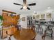 Bright dining area with a large wooden table and seating for four, plus kitchen access at 1627 Bayshore Dr, Englewood, FL 34223