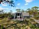 Distinctive home with an A-frame window design, a lovely porch, and a well-manicured lawn at 1627 Bayshore Dr, Englewood, FL 34223