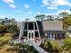 Charming A-frame home with a large window, cozy patio, and beautiful curb appeal at 1627 Bayshore Dr, Englewood, FL 34223