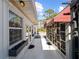 Exterior of home featuring a walkway between the main house and the screened in area, providing access to outdoor spaces at 1627 Bayshore Dr, Englewood, FL 34223