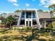 A unique A-frame home with manicured lawn, featuring outdoor sitting and garden, creating a serene and inviting space at 1627 Bayshore Dr, Englewood, FL 34223