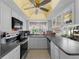 Well-lit kitchen with white cabinets, breakfast bar, and a window overlooking the outdoors at 1627 Bayshore Dr, Englewood, FL 34223