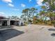 View of outbuilding with open bay and workshop space, offering ample room for storage, projects, and hobbies at 1627 Bayshore Dr, Englewood, FL 34223