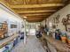 View of an organized shed with workbench, shelving, storage and covered area, ideal for projects and storage needs at 1627 Bayshore Dr, Englewood, FL 34223