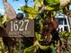 Street sign reading '1627 Bayshore Drive' surrounded by desert landscaping with a view of the modern home's facade at 1627 Bayshore Dr, Englewood, FL 34223