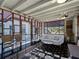 Bright sunroom with a geometric pattern rug and comfortable seating at 1627 Bayshore Dr, Englewood, FL 34223