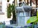 Close-up of an outdoor water feature with running water surrounded by lush plants, creating a tranquil ambiance at 1627 Bayshore Dr, Englewood, FL 34223