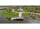 Aerial view of a lakeside trail leading to a gazebo, with a dock and boardwalk at 19715 Tortuga Cay Dr, Venice, FL 34293