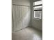 Bedroom featuring a double door closet, tile floors, and a window overlooking the backyard at 19715 Tortuga Cay Dr, Venice, FL 34293