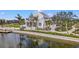 Beautiful community building with manicured lawns, landscaping, and scenic lakeside views at 19715 Tortuga Cay Dr, Venice, FL 34293