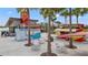 Exterior view of an outdoor amenity area with seating and small eateries at 19715 Tortuga Cay Dr, Venice, FL 34293