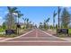 Downtown Wellen Park entrance with brick road, palm trees, and signage at 19715 Tortuga Cay Dr, Venice, FL 34293