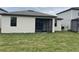 Rear exterior featuring a covered lanai and a manicured lawn at 19715 Tortuga Cay Dr, Venice, FL 34293