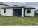 Back exterior view of home featuring screened in lanai and neutral color scheme at 19715 Tortuga Cay Dr, Venice, FL 34293