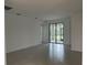 Spacious living room with tiled floors and sliding glass doors to the backyard at 19715 Tortuga Cay Dr, Venice, FL 34293