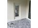 Paver patio features a white exterior door with access to the home at 19715 Tortuga Cay Dr, Venice, FL 34293