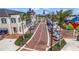 Scenic street view with landscaped medians, mature palm trees, and stylish retail buildings at 19715 Tortuga Cay Dr, Venice, FL 34293